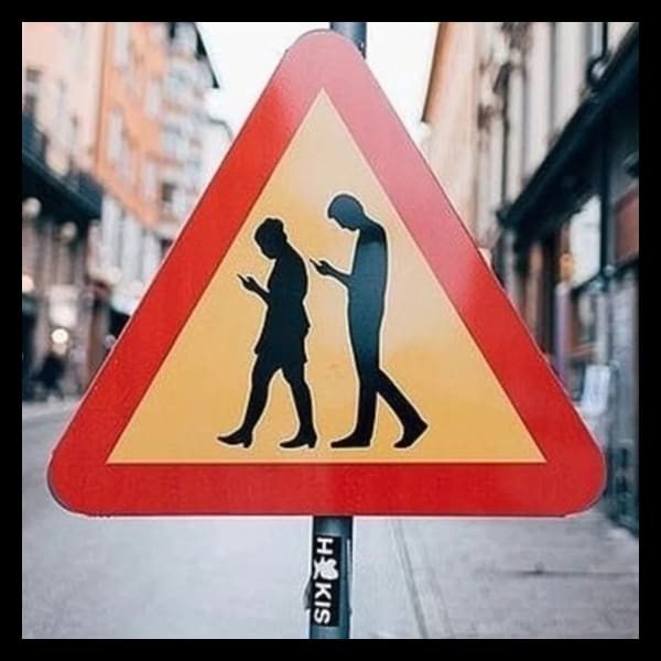 personas mirando el celular mientras caminan